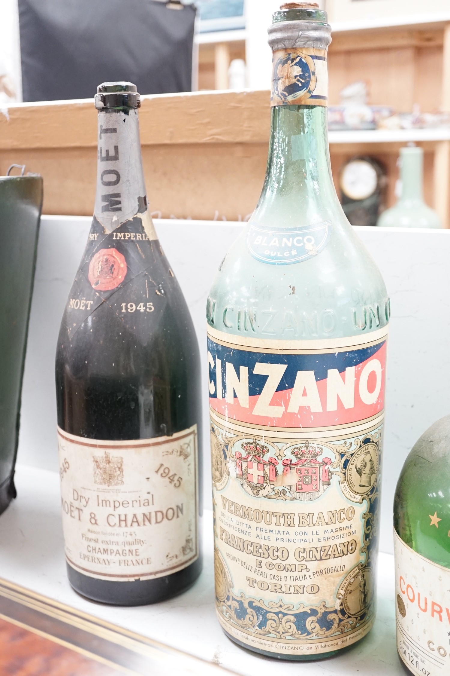 A collection of oversize and advertising bottles for Cinzano, Courvoisier, Moet Chandon, Rouyer Guillet cognac, Grand Opera cognac and Chateau Coufran, largest 52 cm